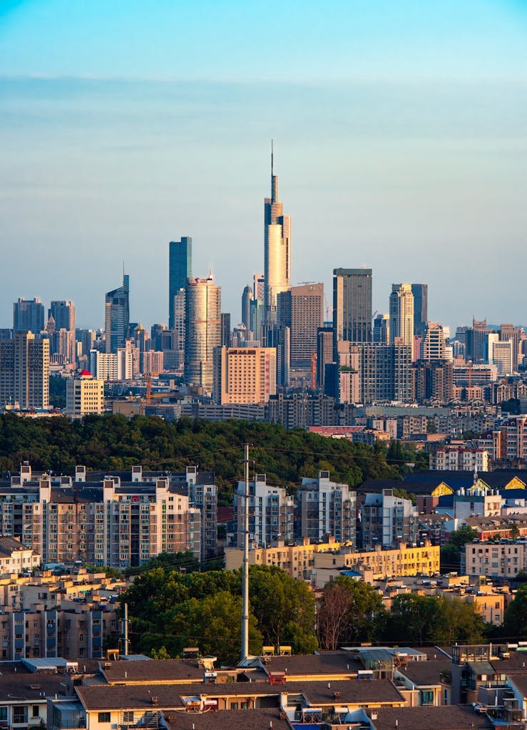 Breathtaking view of Nanjing's urban skyline with iconic skyscrapers at sunset.